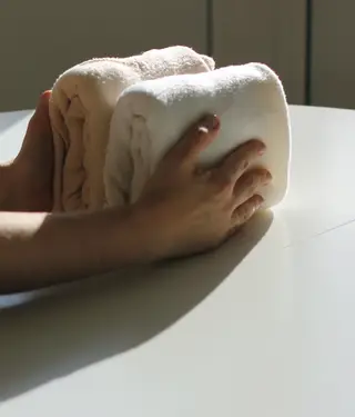 Dobrar a roupa numa espécie de pacotinhos é uma das várias técnicas de organização.