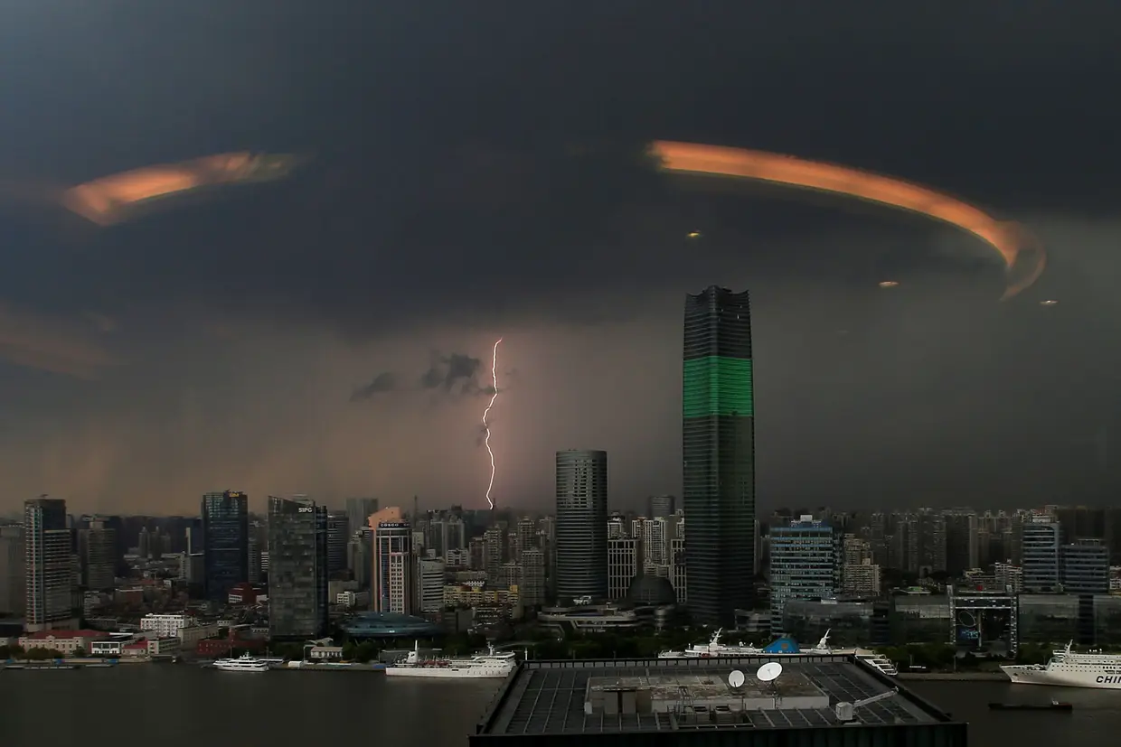 Um relâmpago atinge Xangai, na China, numa fotografia tirada através de uma janela.