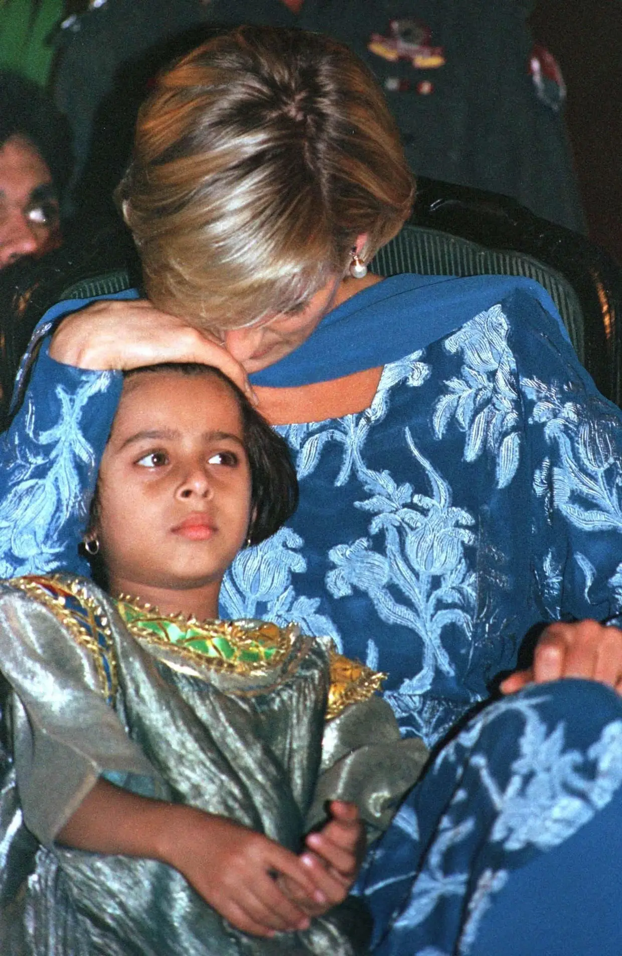 Diana com uma criança de 5 anos, irmã de um menina de cancro, no Paquistão.