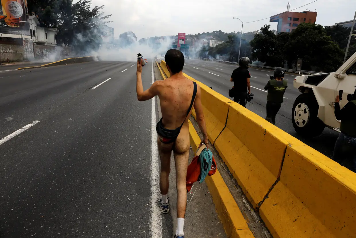 Manifestante desfila sem roupa num protesto contra o Presidente Nicolás Maduro em Caracas, Venezuela.