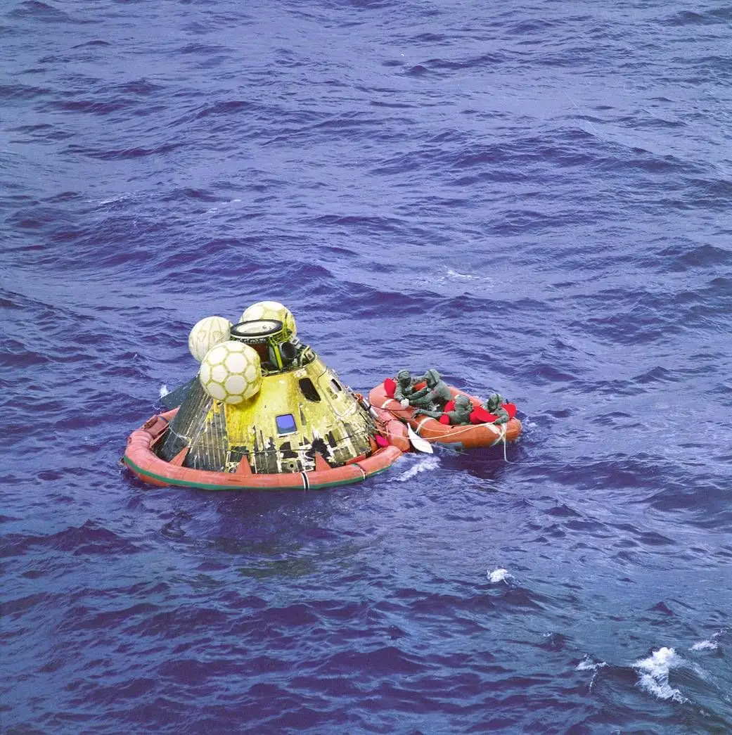 A 24 de julho, uma bola de fogo atravessa a atmosfera terrestre e cai como uma pedra no Oceano Pacífico. A cápsula que transporta os três astronautas está um pouco à deriva mas surgem logo os mergulhadores de elite norte-americanos para os retirar.