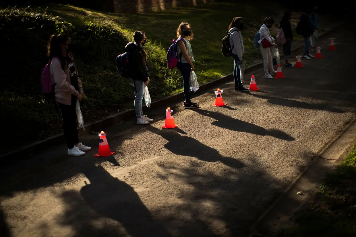 Estudantes com máscaras esperam na fila para entrar na escola, Bruxelas, Bélgica.