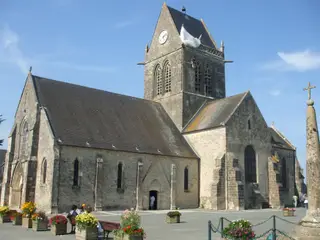 Igreja de Sainte-Mére-Église, vendo-se suspenso da torre o manequim pára-quedista alegórico a John Steele