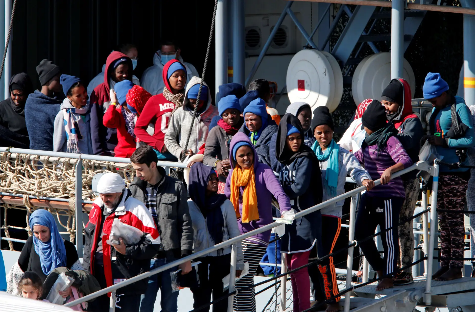 Migrantes prestes a desembarcar no porto italiano da Catânia (Sicília)