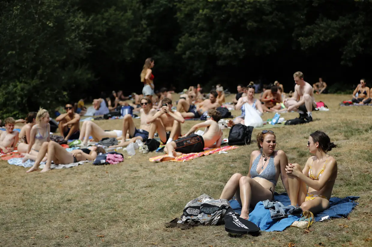 Os habituais passeios por Hampstead Heath deram lugar a momentos de relaxamento sobre a relva, em Londres, Reino Unido