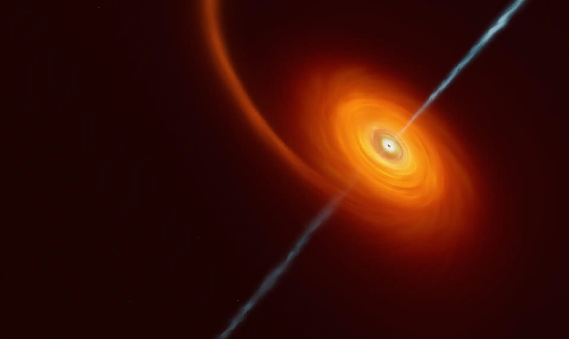 Esta imagem artística ilustra como é que uma estrela que se aproxima demasiado de um buraco negro fica "espremida" pela enorme atração gravitacional deste objeto. Algum do material estelar é puxado e roda em torno do buraco negro, formando o disco que podemos ver nesta imagem. Em alguns casos raros como este, jatos de matéria e radiação são lançados a partir dos pólos do buraco negro