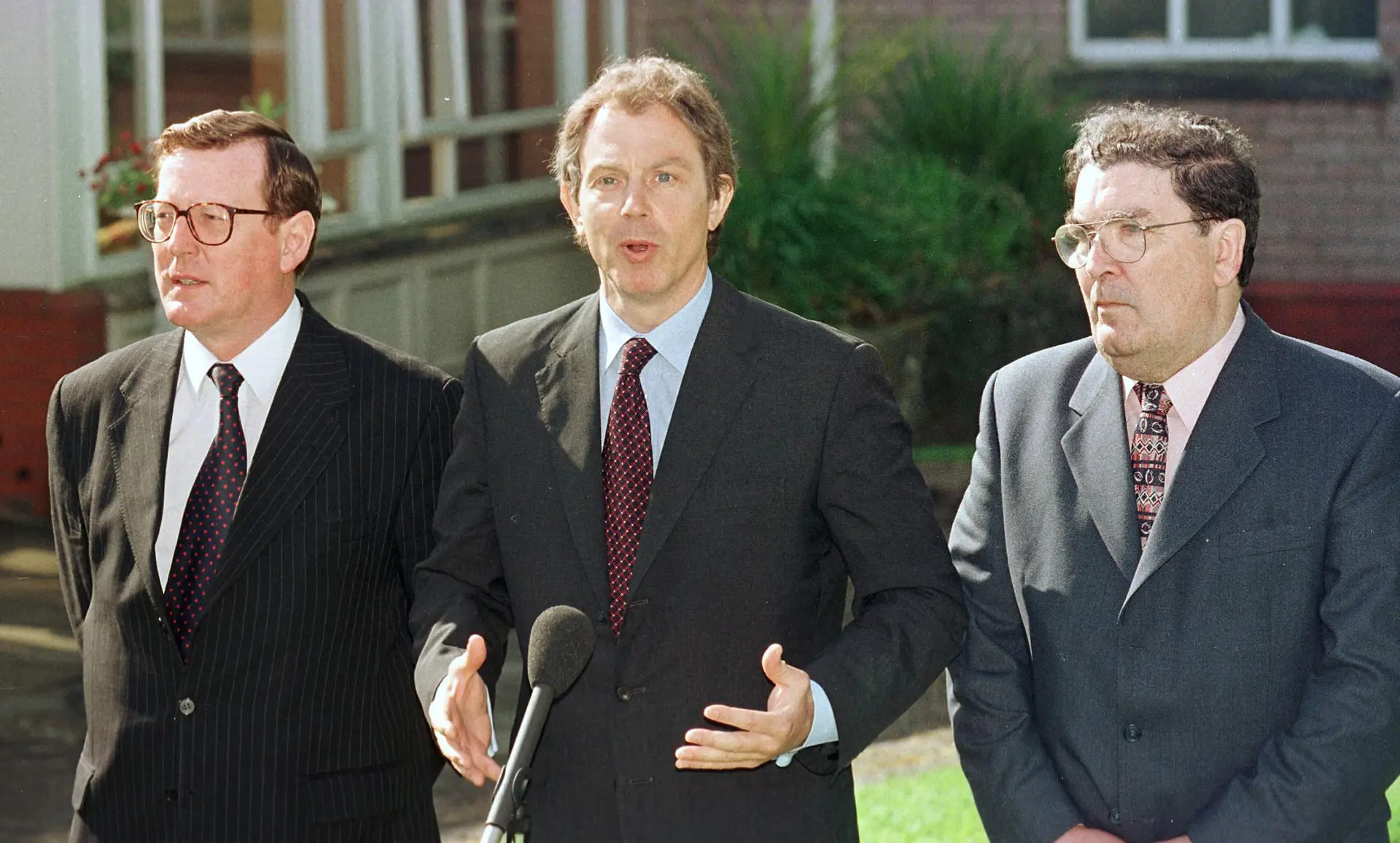 O primeiro-ministro britânico Tony Blair (ao centro na imagem) com os dirigentes norte-irlandeses responsáveis pelo Acordo de Sexta-feira Santa, em 1998. À esquerda, o unionista David Trimble; à direita, o republicano John Hume 