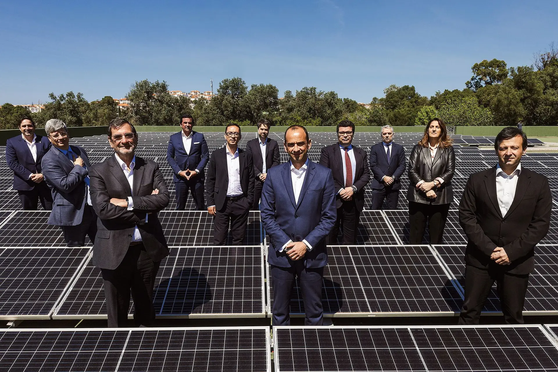 Participantes na conferência retratados junto dos painéis solares que alimentam parte das necessidades energéticas do Edifício Impresa