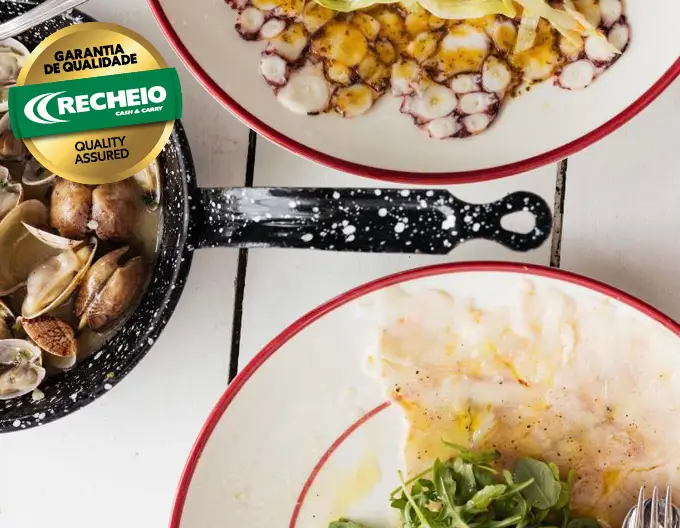 Peixe fresco e marisco com os pés na areia