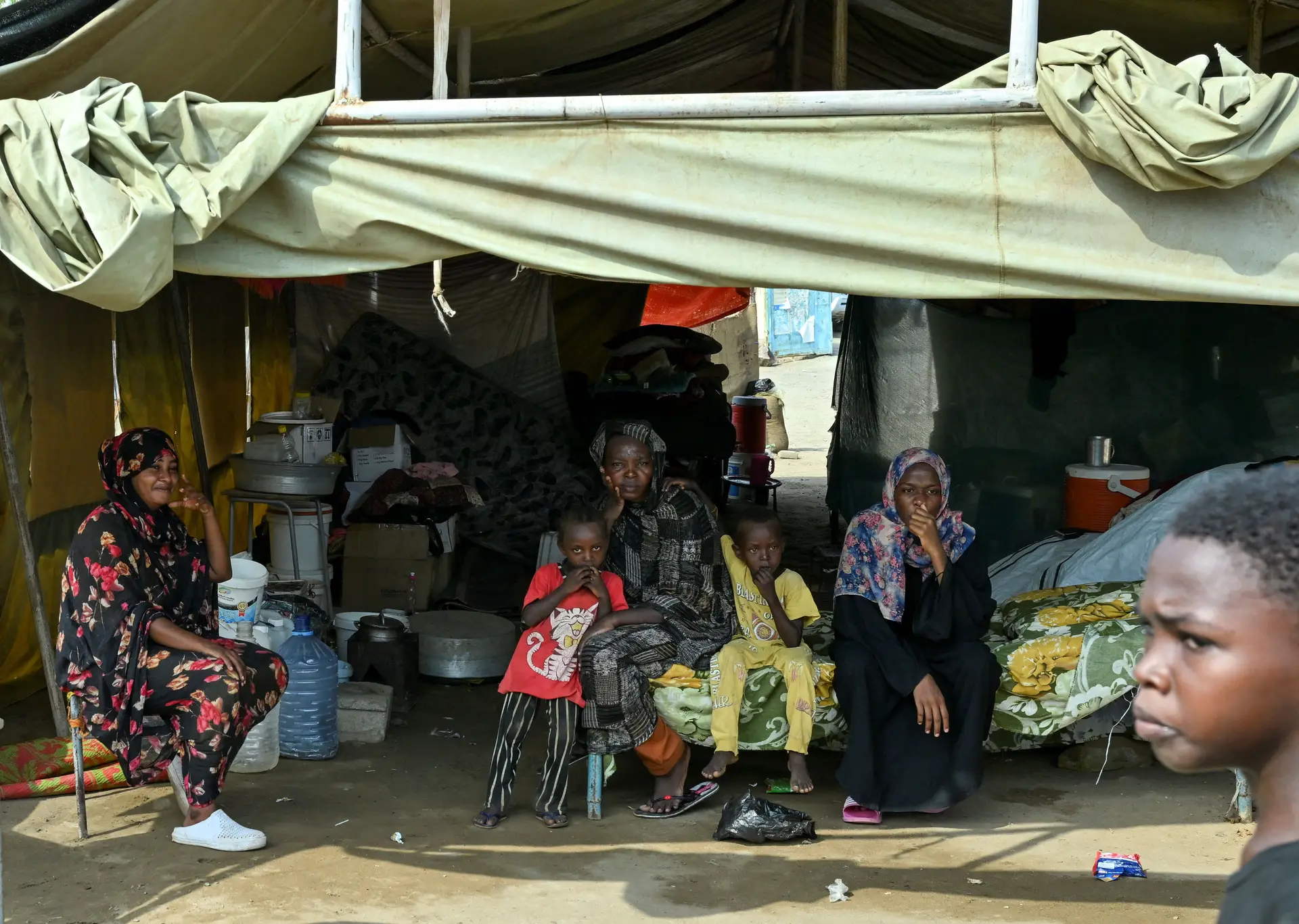 Deslocados sudaneses refugiam-se no interior de tendas onde funcionava uma escola e que servem agora de abrigo a famílias
