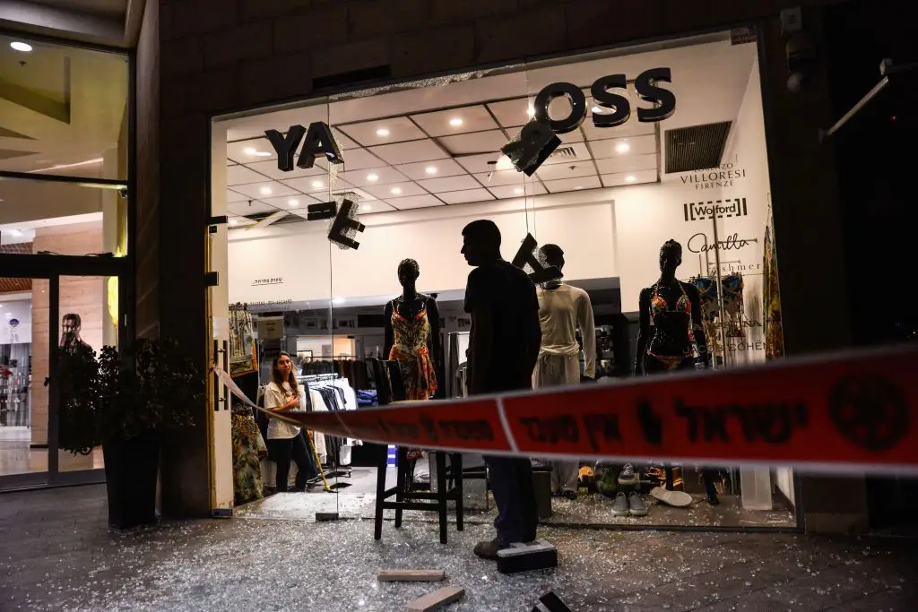 Estragos provocados por mísseis iranianos num espaço comercial, no centro de Israel
