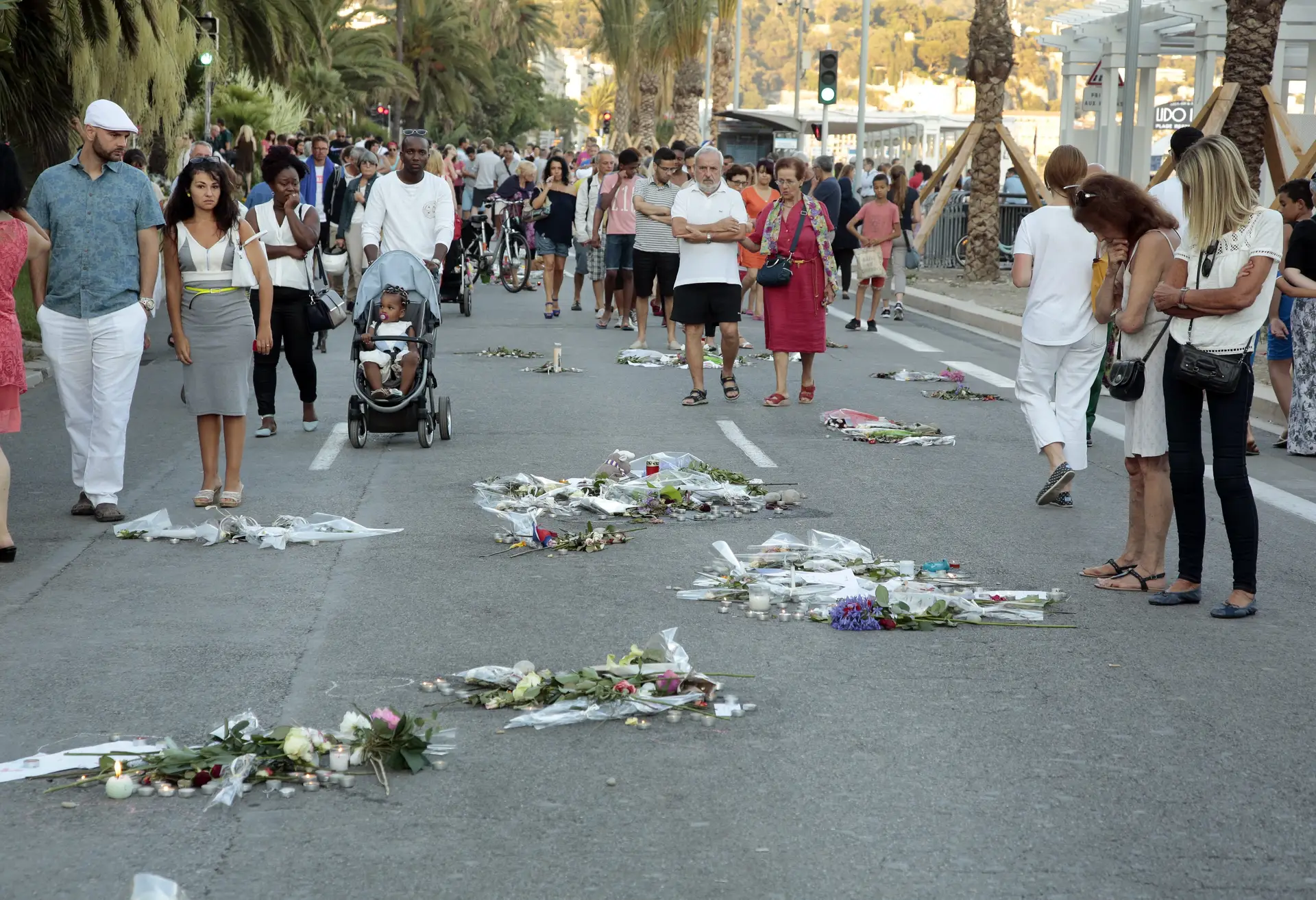 Várias pessoas prestam homenagem às vítimas do ataque ocorrido na cidade francesa de Nice, em 2016