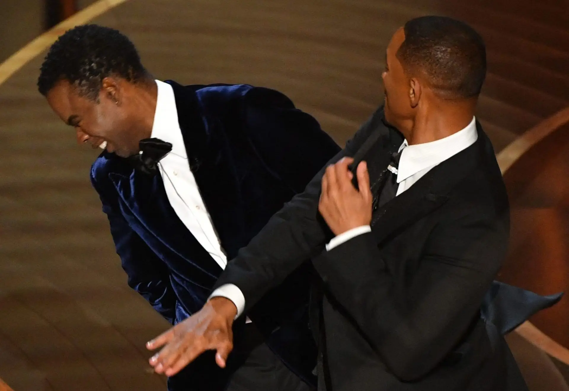 US actor Will Smith (R) slaps US actor Chris Rock onstage during the 94th Oscars at the Dolby Theatre in Hollywood, California on March 27, 2022. (Photo by Robyn Beck / AFP) (Photo by ROBYN BECK/AFP via Getty Images)