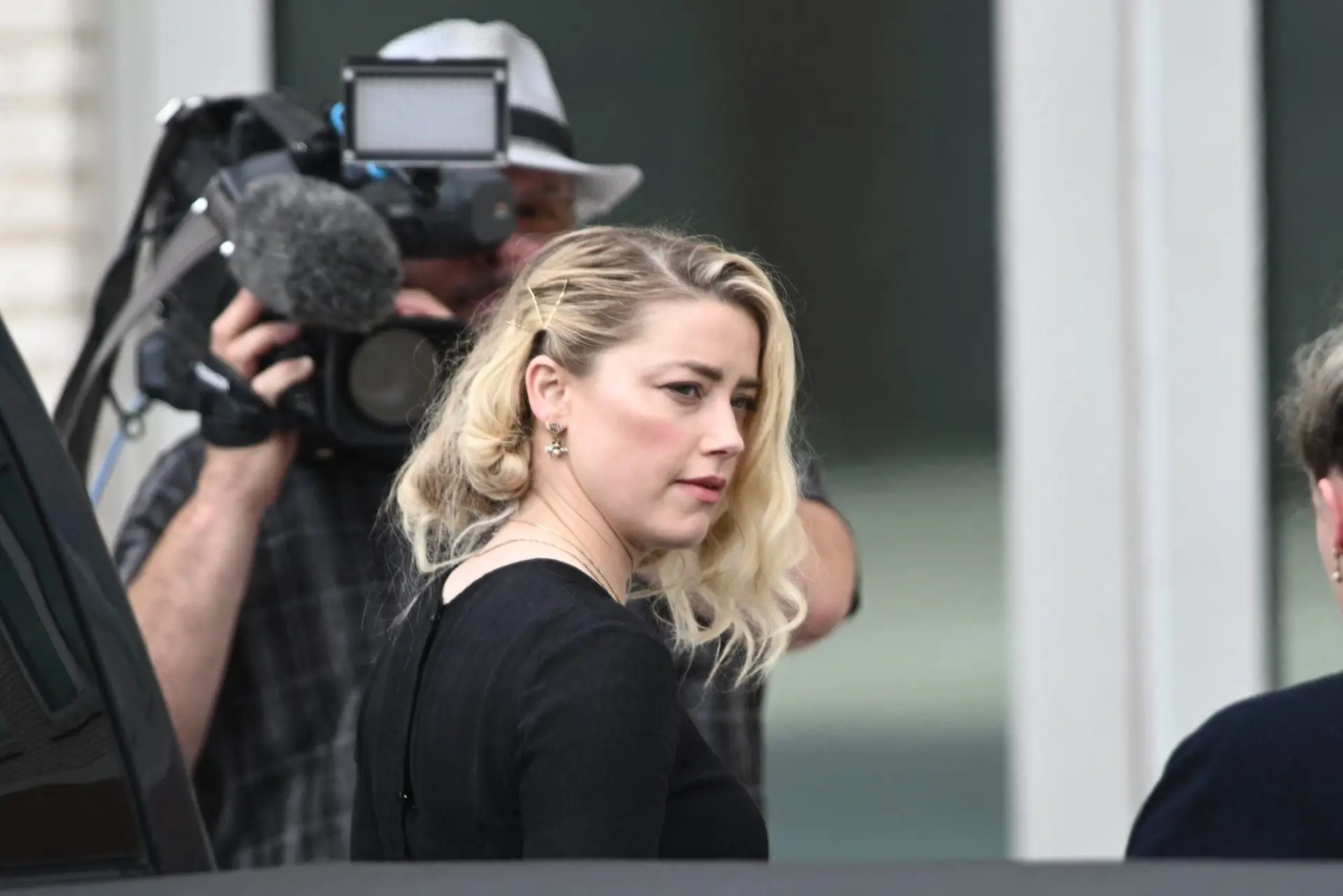 US actress Amber Heard arrives to hear the verdict in the Depp v. Heard trial at the Fairfax County Circuit Courthouse in Fairfax, Virginia, on June 1, 2022. – The jury reached a verdict on Wednesday in the high-profile defamation case between actor Johnny Depp and his ex-wife Heard. The seven-person Virginia jury has been deliberating for about 13 hours over three days in Fairfax County Circuit Court near the US capital. The court said the verdict is to be read out at 3:00 pm (1900 GMT). (Photo by Brendan SMIALOWSKI / AFP) (Photo by BRENDAN SMIALOWSKI/AFP via Getty Images)