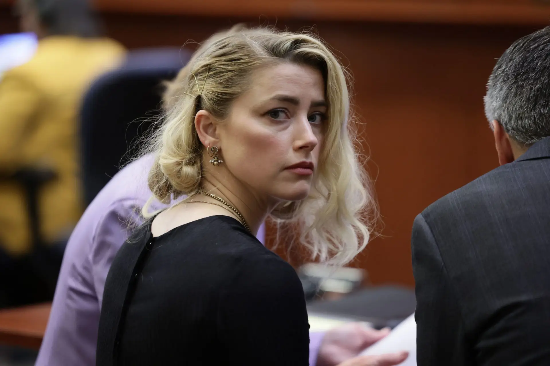 US actress Amber Heard waits before the jury said that they believe she defamed ex-husband Johnny Depp, while announcing split verdicts in favor of both her ex-husband Johnny Depp and Heard on their claim and counter-claim in the Depp v. Heard civil defamation trial at the Fairfax County Circuit Courthouse in Fairfax, Virginia, on June 1, 2022. – A US jury on Wednesday found Johnny Depp and Amber Heard defamed each other, but sided far more strongly with the “Pirates of the Caribbean” star following an intense libel trial involving bitterly contested allegations of sexual violence and domestic abuse. (Photo by EVELYN HOCKSTEIN / POOL / AFP) (Photo by EVELYN HOCKSTEIN/POOL/AFP via Getty Images)