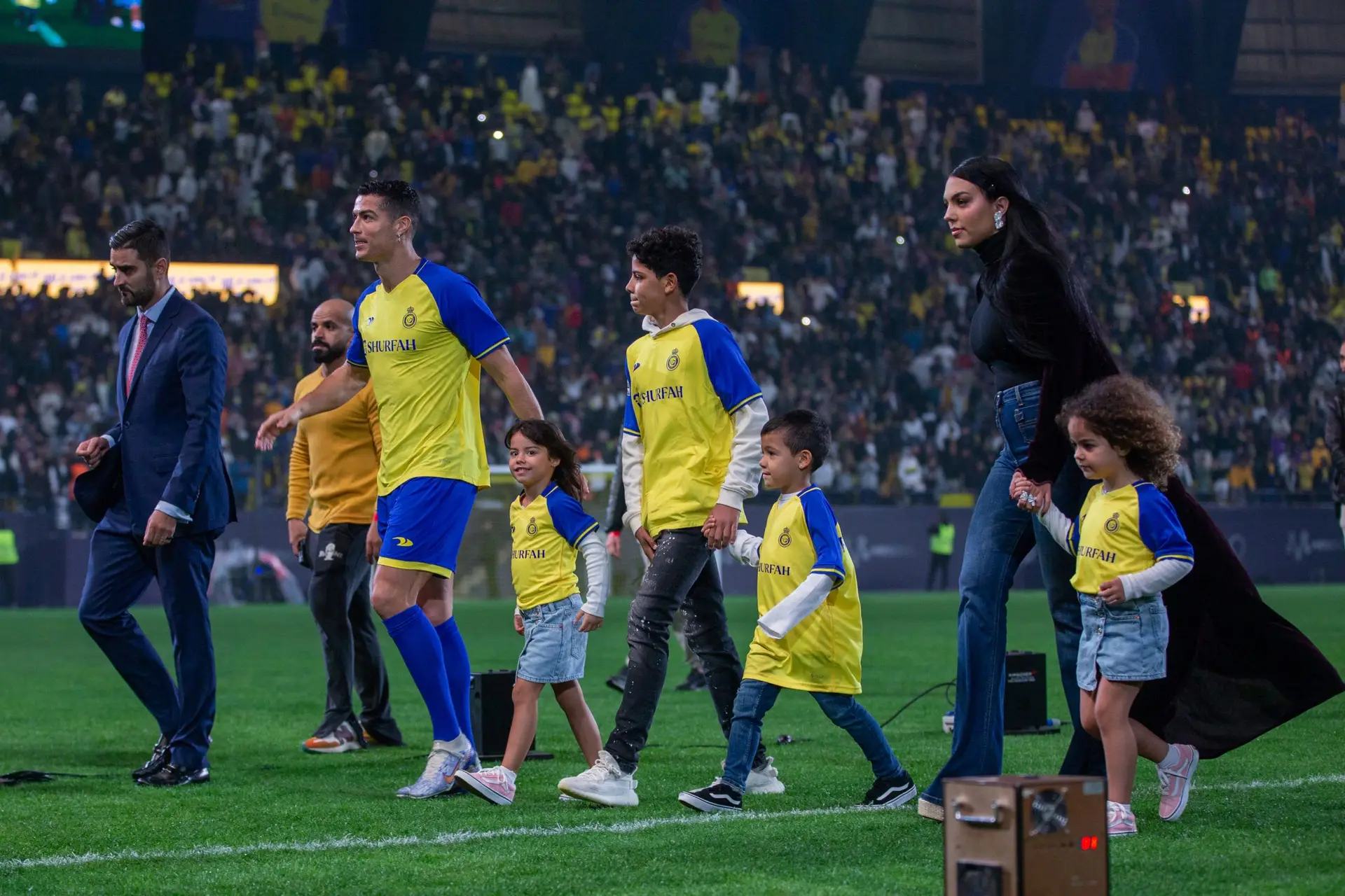 RIYADH, SAUDI ARABIA – JANUARY 03: Cristiano Ronaldo accompanied by his partner Georgina Rodriguez and his son Cristiano Ronaldo Jr, greet the crowd during the official unveiling of Cristiano Ronaldo as an Al Nassr player at Mrsool Park Stadium on January 3, 2023 in Riyadh, Saudi Arabia. (Photo by Yasser Bakhsh/Getty Images)