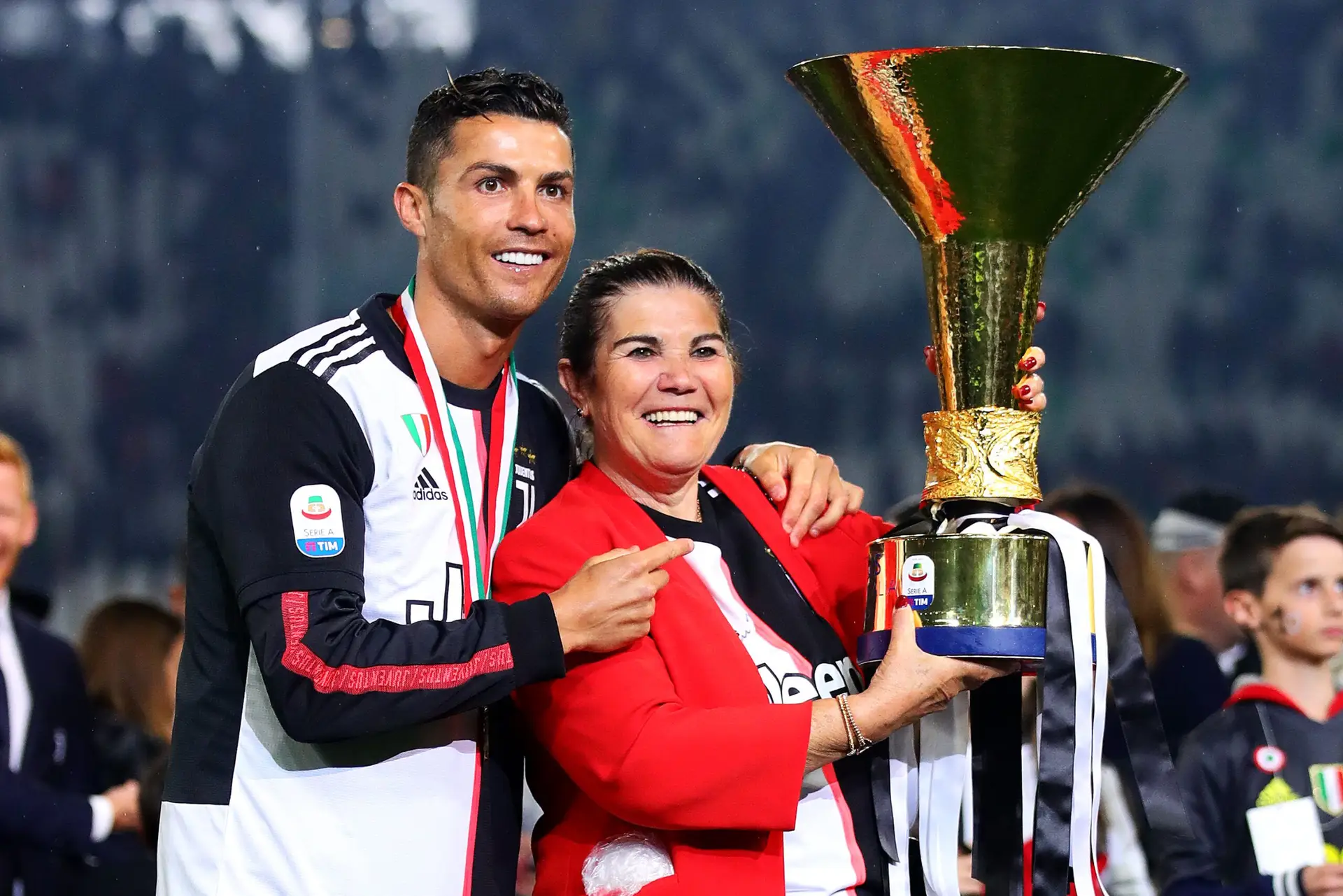 TURIN, ITALY – MAY 19: Cristiano Ronaldo of Juventus poses with the Serie A trophy alongside his mother Maria Dolores dos Santos Aveiro following the Serie A match between Juventus and Atalanta BC at Allianz Stadium on May 19, 2019 in Turin, Italy. (Photo by Chris Brunskill/Fantasista/Getty Images)