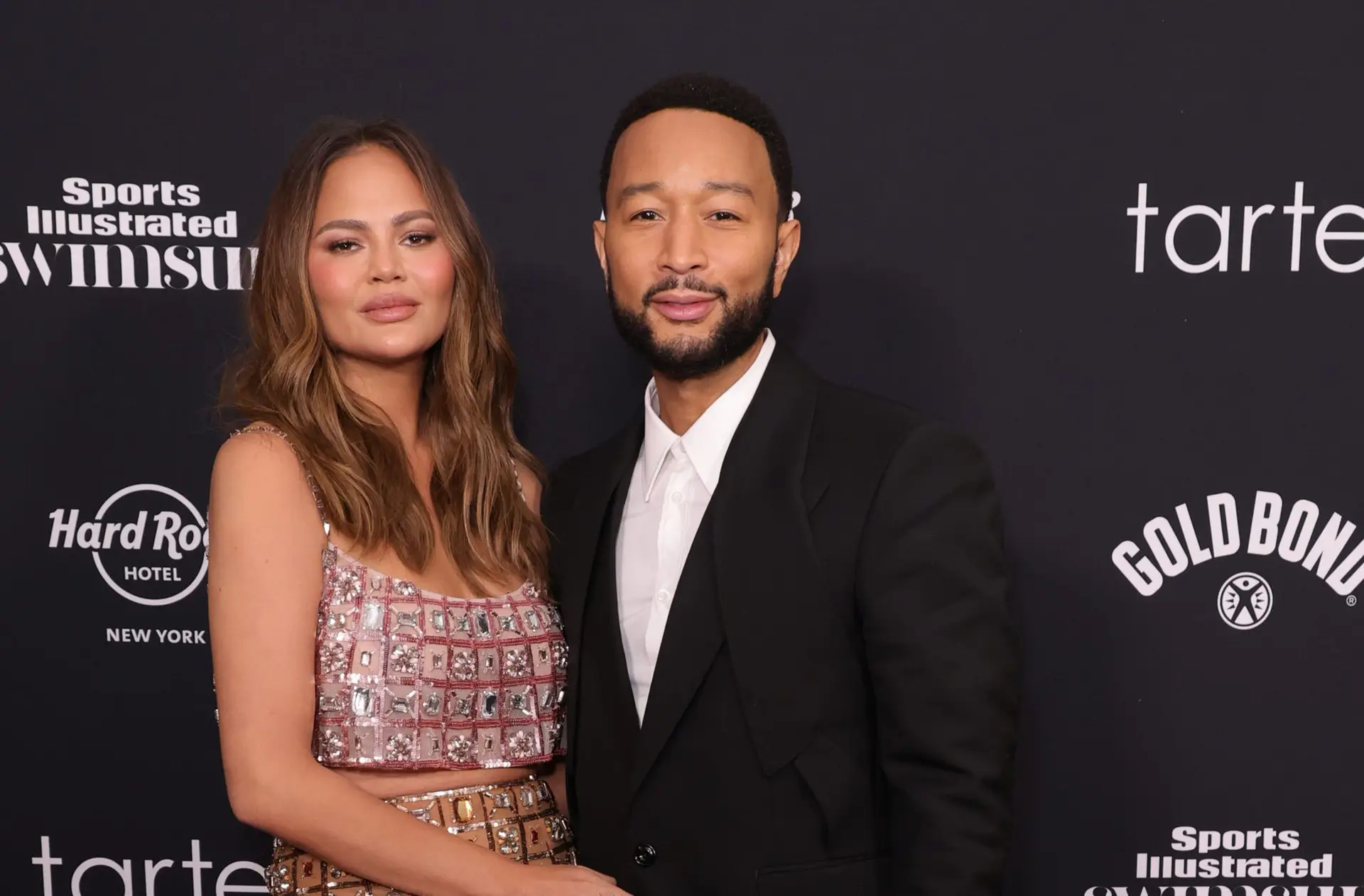 NEW YORK, NEW YORK – MAY 16: (L-R) Chrissy Teigen and John Legend attend the 2024 Sports Illustrated Swimsuit Issue launch party at Hard Rock Cafe – Times Square on May 16, 2024 in New York City. (Photo by Michael Loccisano/Getty Images)