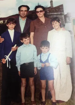 Tuck (à esquerda de camisa e calções) com os pais e os irmãos