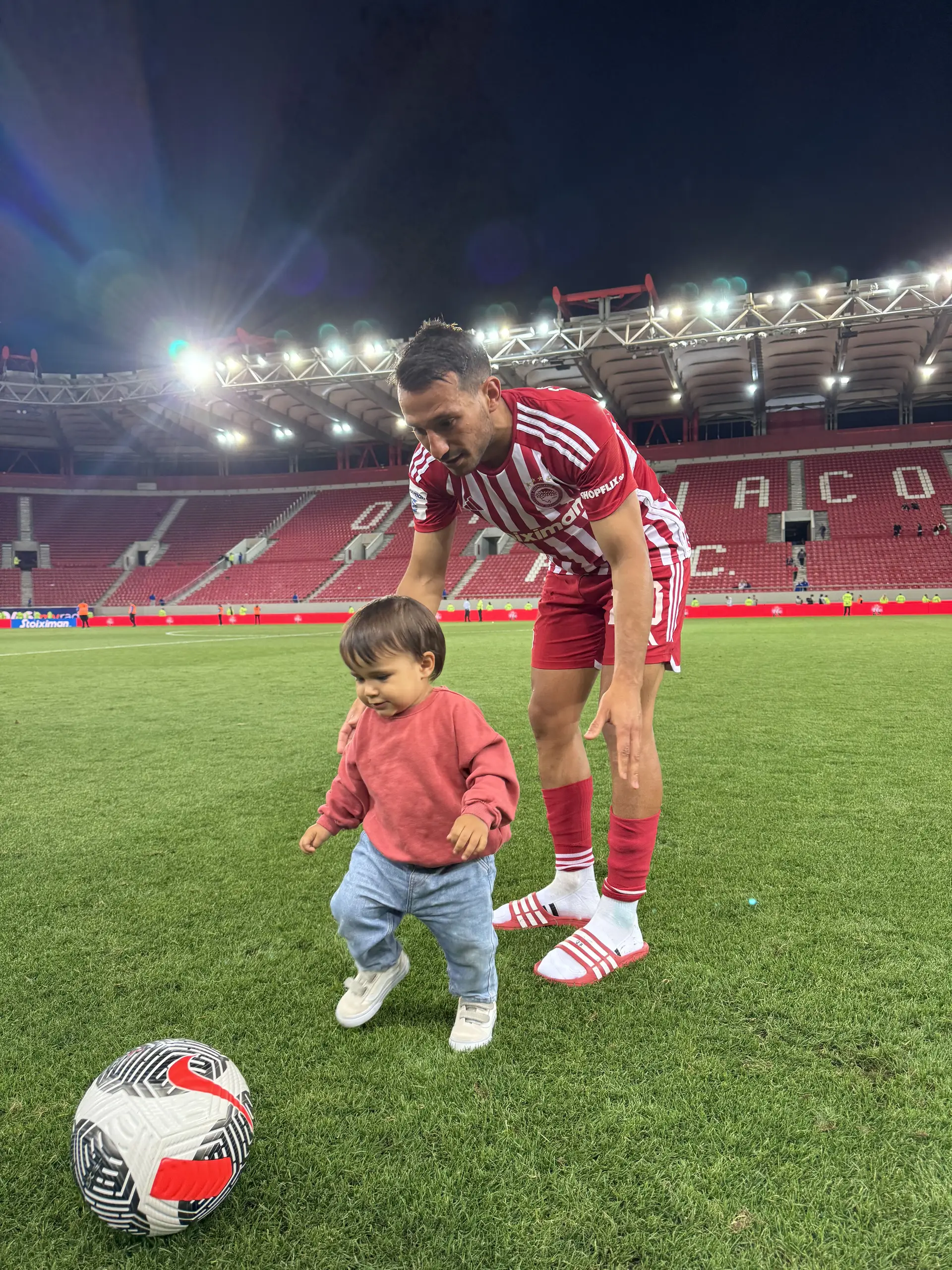 O médio com o filho Salvador, a campo do Olympiacos