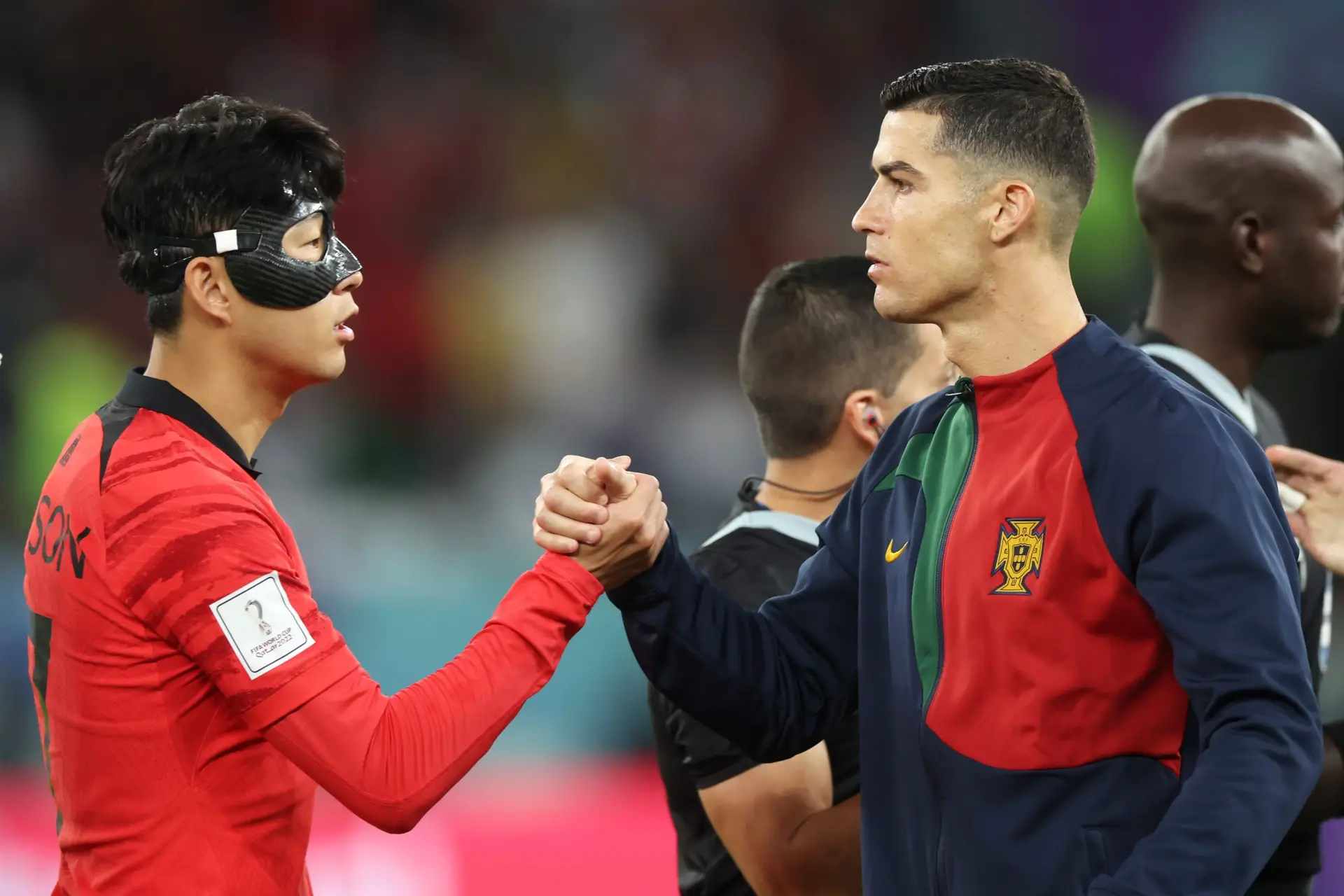 AL RAYYAN, QATAR – DECEMBER 02: Heungmin Son of Korea Republic embraces Cristiano Ronaldo of Portugal prior to the FIFA World Cup Qatar 2022 Group H match between Korea Republic and Portugal at Education City Stadium on December 02, 2022 in Al Rayyan, Qatar. (Photo by Alex Grimm/Getty Images)