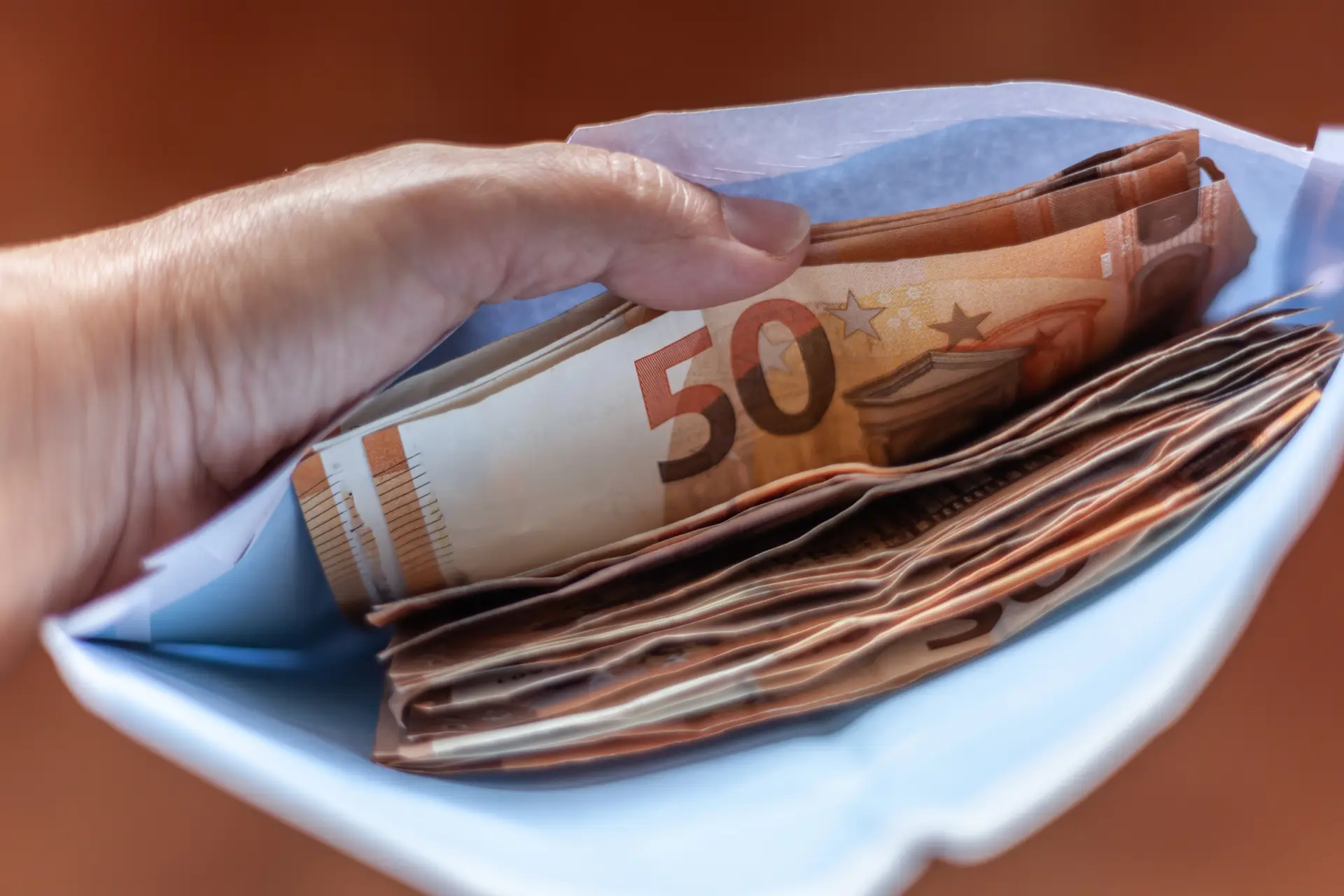 Putting money in an envelope
