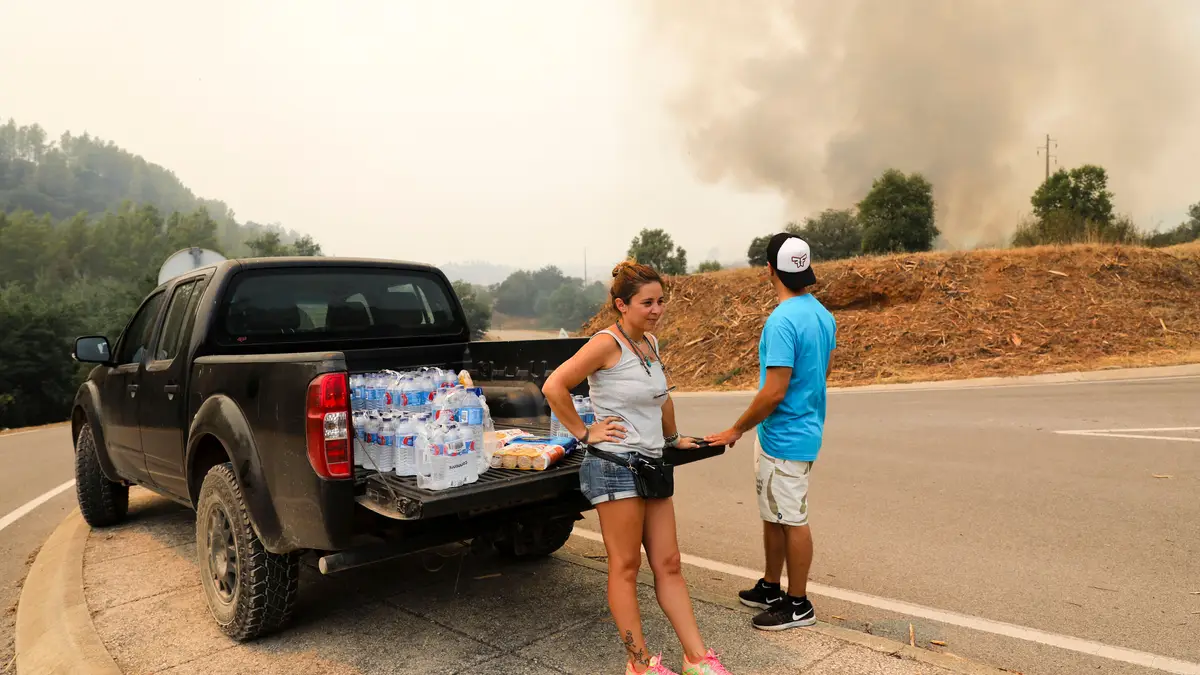 Populares com água e mantimentos para os bombeiros na zona do incêndio que lavra desde sexta-feira em Monchique na zona de Rasmalho em direção a Porto de Lagos, Portimão,  07  de agosto de 2018. 
