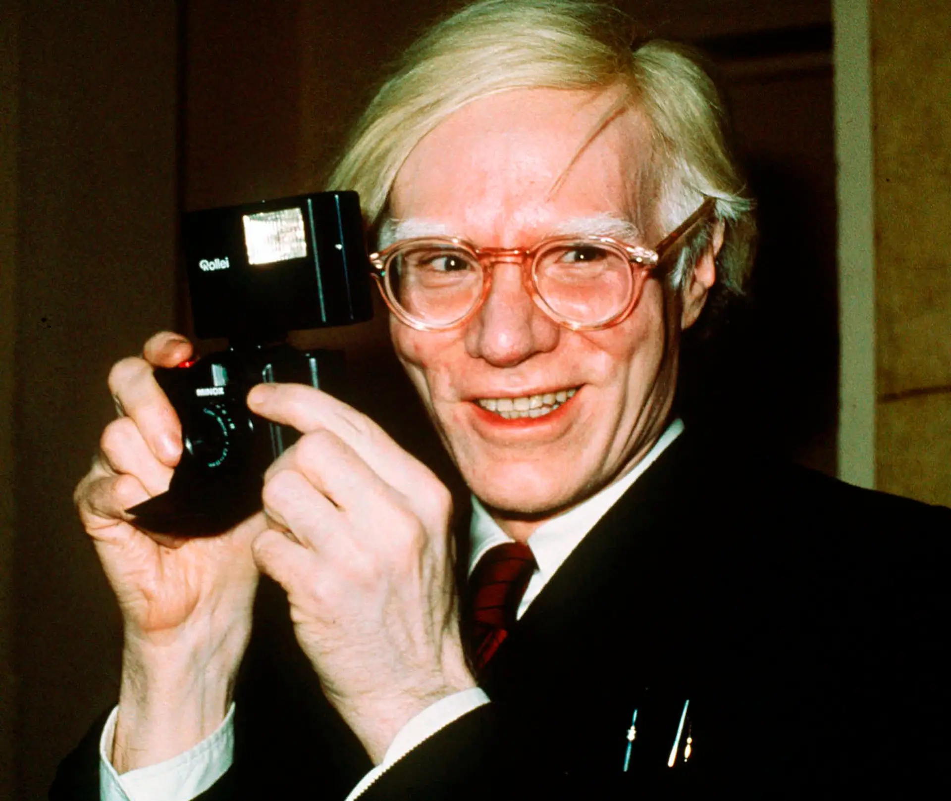 FILE – In this 1976 file photo, pop artist Andy Warhol smiles in New York. The Supreme Court has agreed to review a copyright dispute involving works of art by Warhol and a photographer who took an image of the musician Prince that the works are based on. (AP Photo/Richard Drew, File)