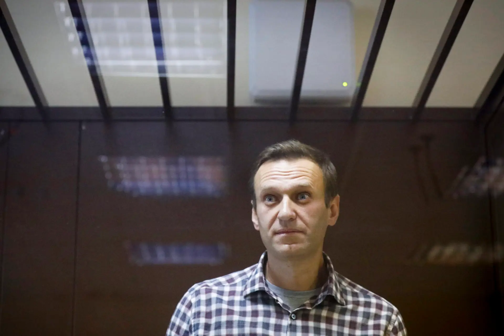 FILE – In this Feb. 20, 2021, file photo, Russian opposition leader Alexei Navalny stands in a cage in the Babuskinsky District Court in Moscow, Russia. Russia is holding three days of voting and there’s no expectation that United Russia, the party devoted to President Vladimir Putin, will lose its dominance in the State Duma. The main question is whether the party will retain its two-thirds majority that allows it to amend the constitution. Another question is whether the Smart Voting strategy devised by Navalny will prove viable against United Russia. (AP Photo/Alexander Zemlianichenko, File)