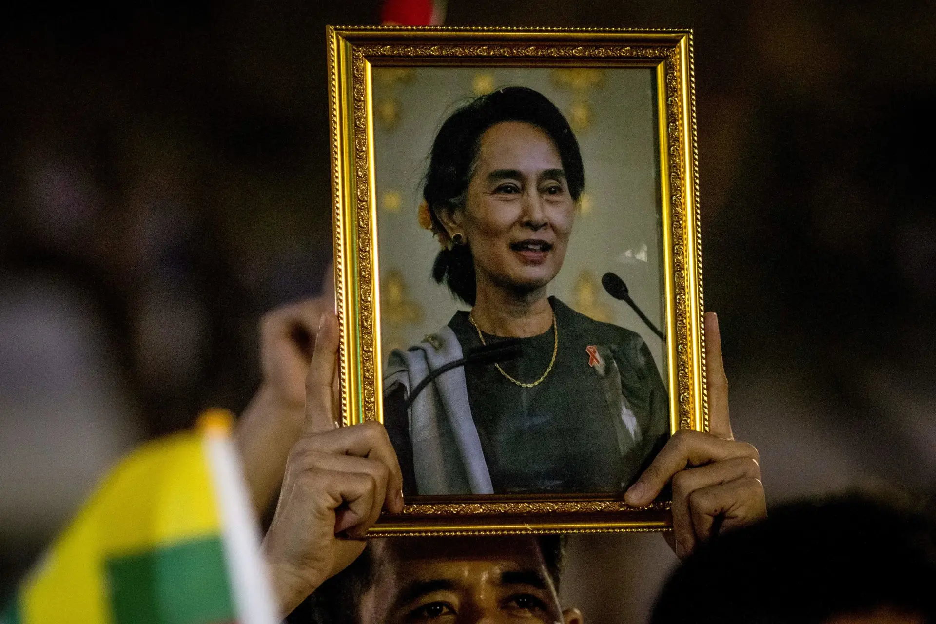 A protester holds up a picture of detained Myanmar civilian leader Aung San Suu Kyi during a rally outside the United Nations ESCAP building in Bangkok on March 5, 2021 calling for the release of political prisoners following the military coup in their homeland. (Photo by Jack TAYLOR / AFP) (Photo by JACK TAYLOR/AFP via Getty Images)
