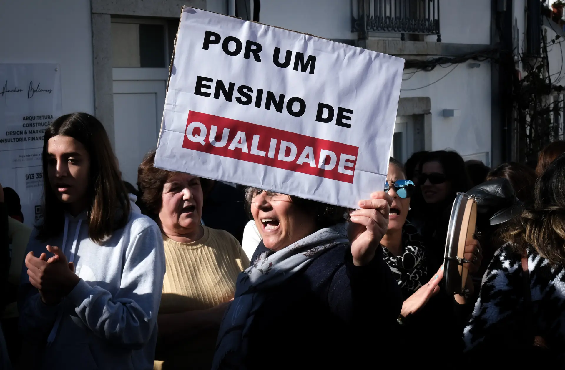 Uma manifestante exibe um cartaz onde se lê "Por Um Ensino de Qualidade" durante a protesto dos professores e auxiliares de ação educativa da escola Secundária de Palmela, junto aos Paços do Concelho de Palmela