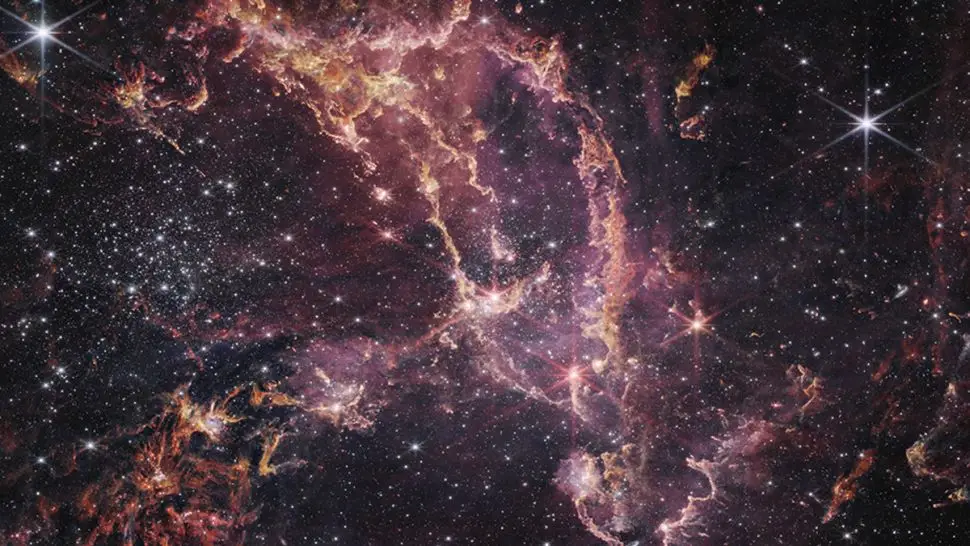 A formação de estrelas dentro da Pequena Nuvem de Magalhães revelada pelo Telescópio Espacial James Webb.