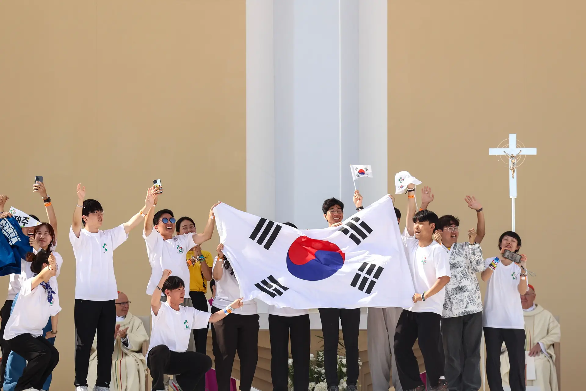 Jovens sobem ao palco com a bandeira da Coreia do Sul após o Papa Francisco anunciar que a próxima Jornada Mundial da Juventude vai realizar-se em Seul.