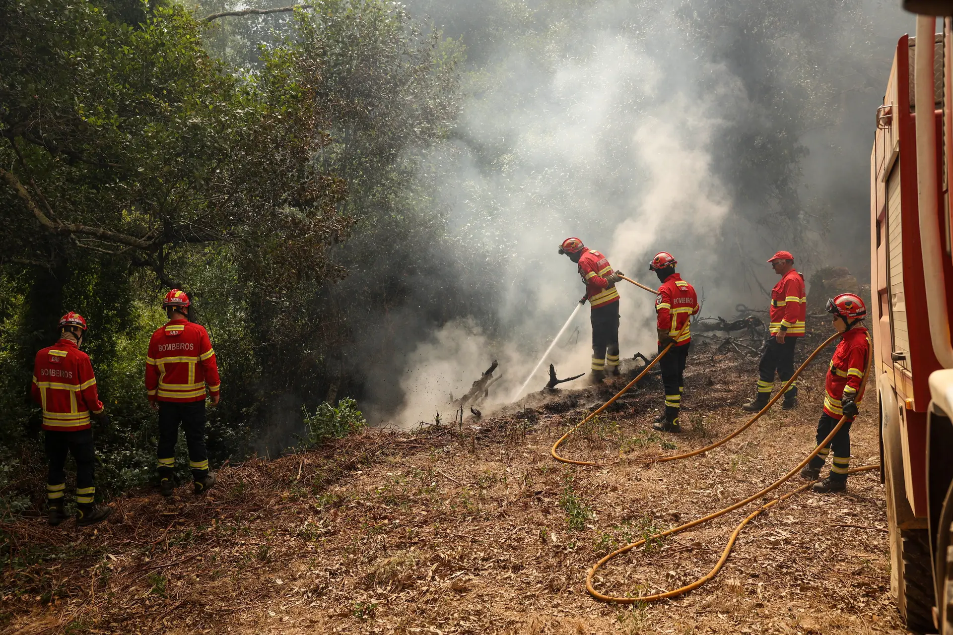 Bombeiros combatem incêndio.