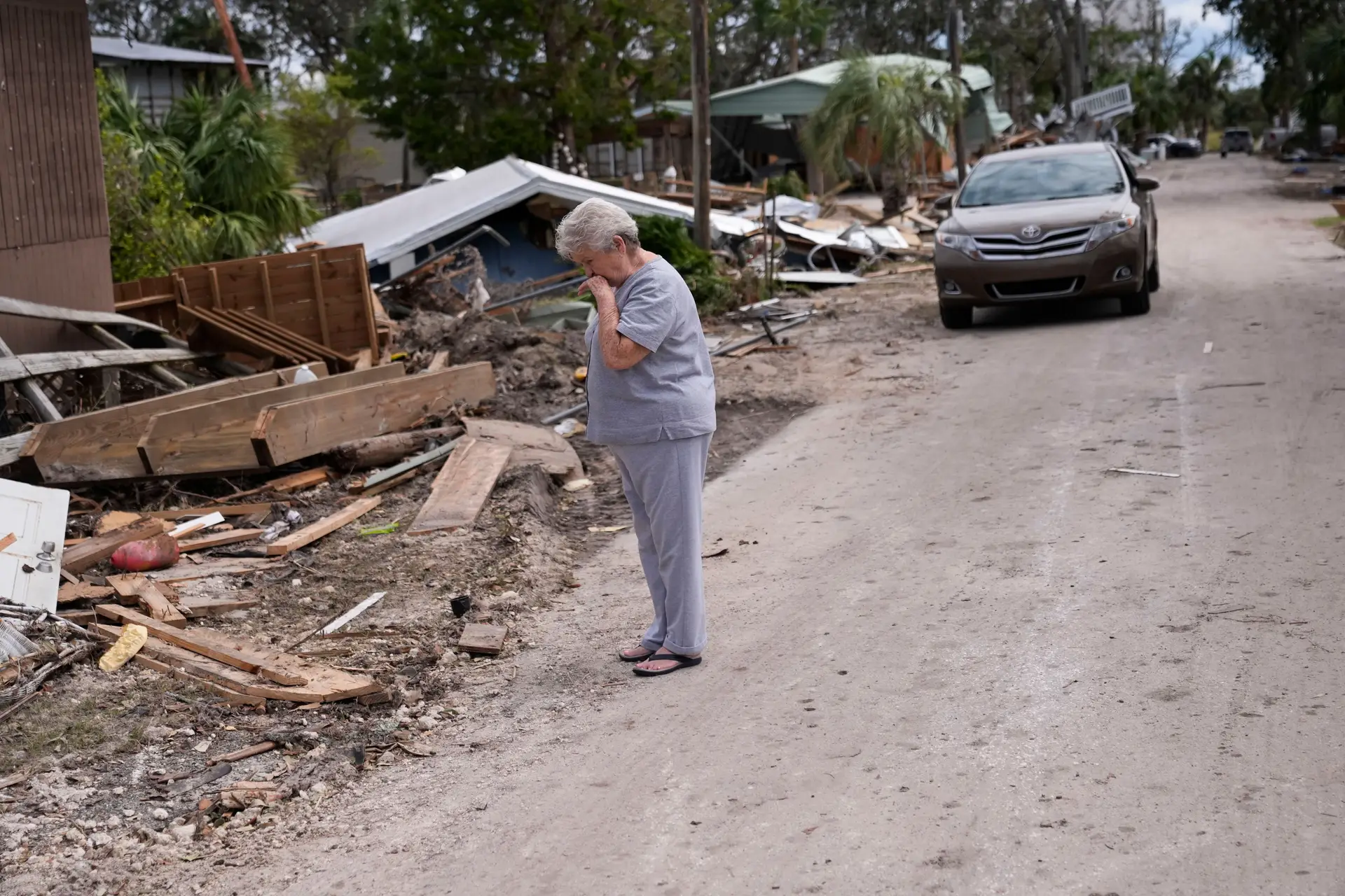 Elderly woman crying after seeing her home destroyed by Hurricane Helene