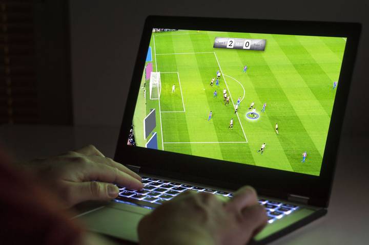 Computer screen ⁢showing ​a football management game