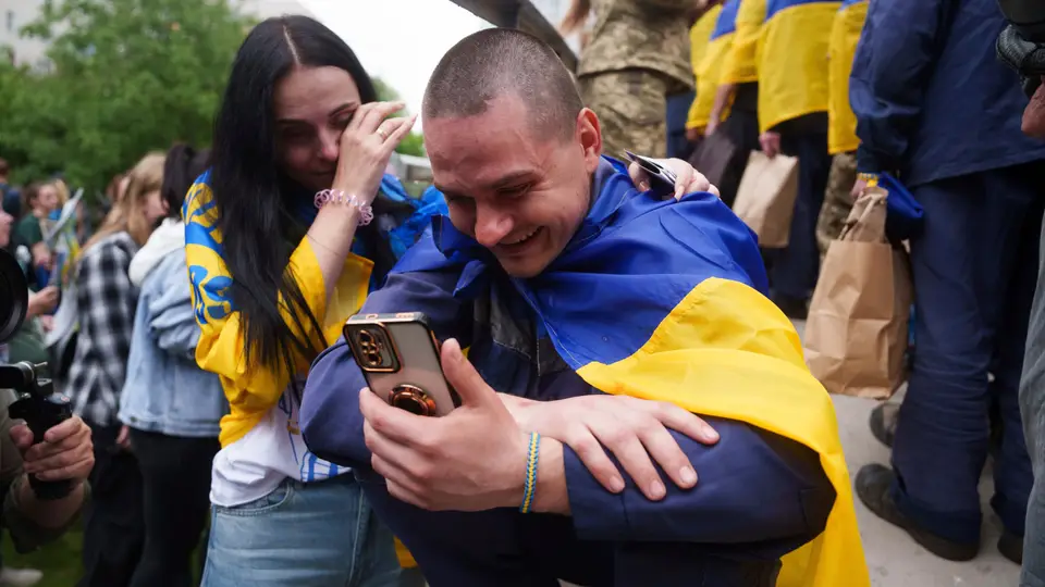Um soldado ucraniano fala ao telefone com um familiar depois de regressar do cativeiro durante uma troca de prisioneiros de guerra entre a Rússia e a Ucrânia, na região de Chernyhiv, Ucrânia, sábado, 24 de maio de 2025. 
