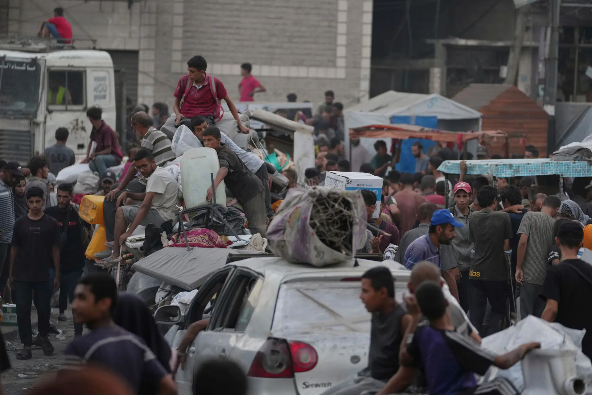 Palestinianos deslocados a fugir de Jabaliya seguem com os seus pertences por uma rua na Cidade de Gaza, esta terça-feira, 26 de agosto de 2025.